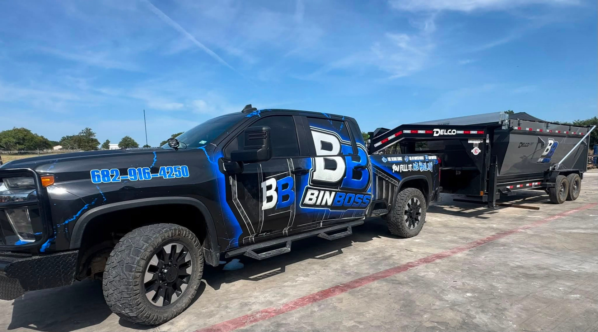 BinBoss DFW truck towing a roll-off dumpster trailer in Cleburne, Texas